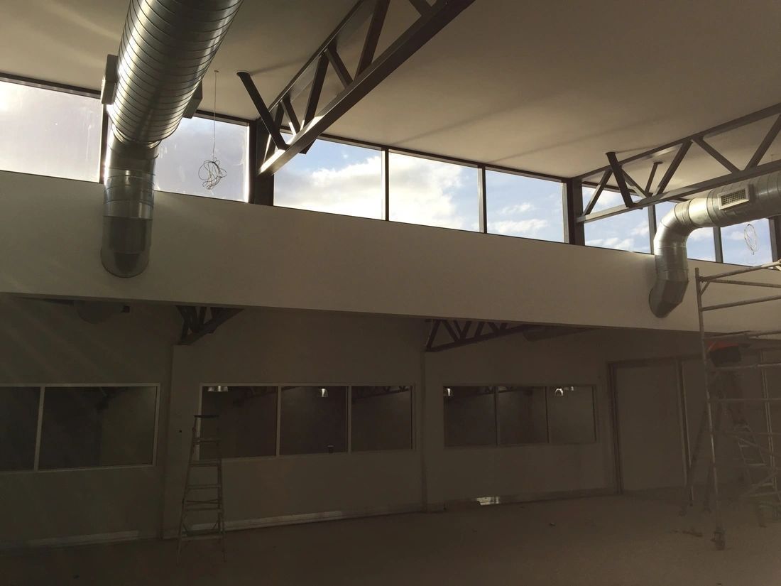 A large empty room with a lot of windows