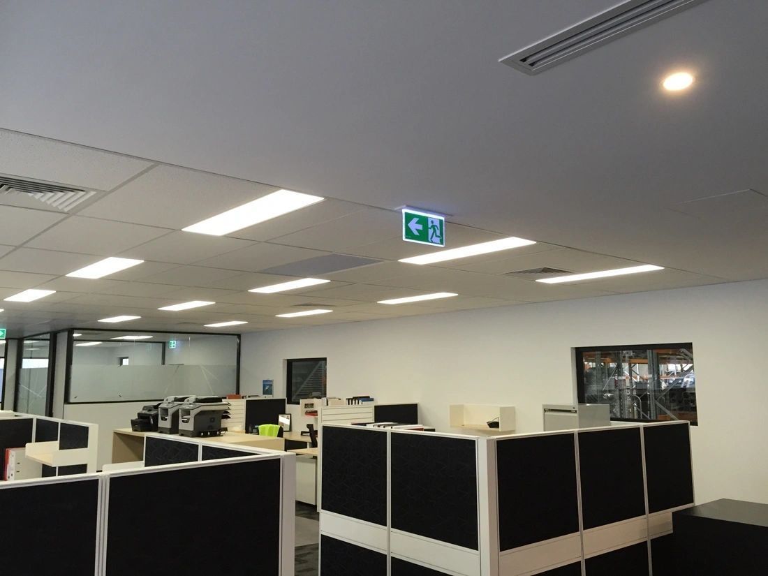 An office with cubicles and a sign that says exit