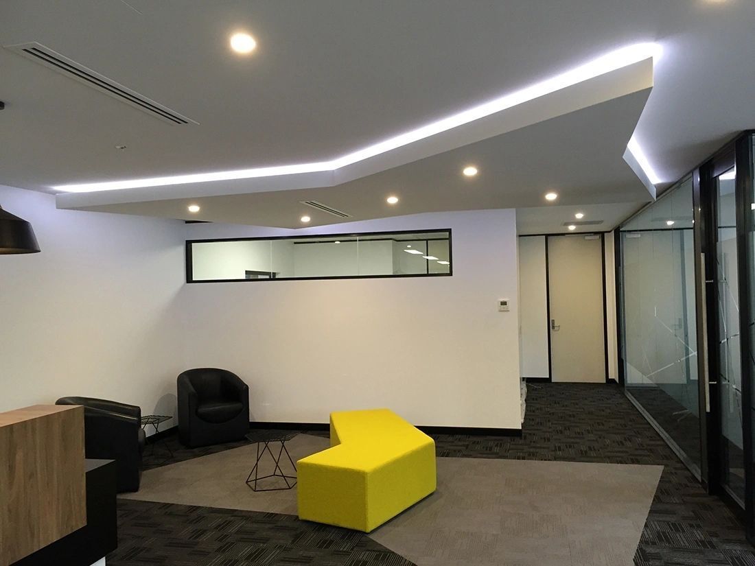 A hard hat is sitting on top of a blueprint on a table.