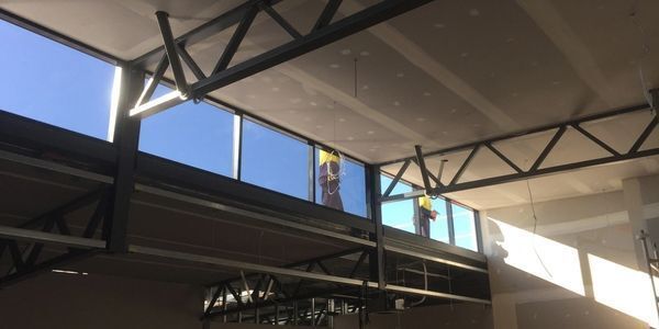 A man is installing rockwool insulation on a wall.