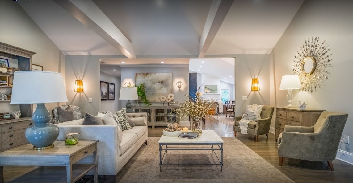 recessed lighting and wall sconces in furnished living room