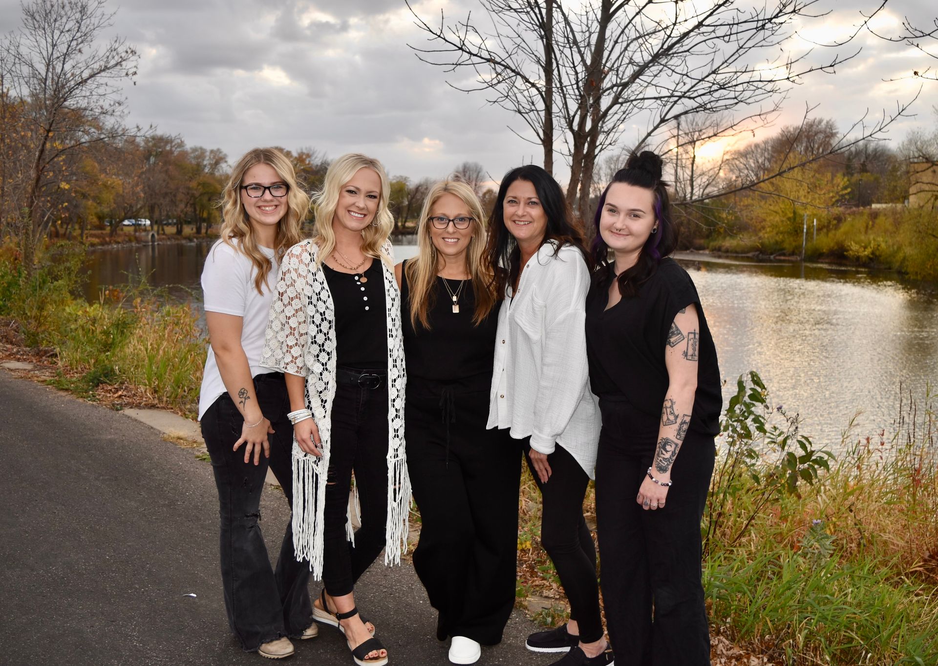 The Professionals from Family Hair salon are smiling for the camera outside.
