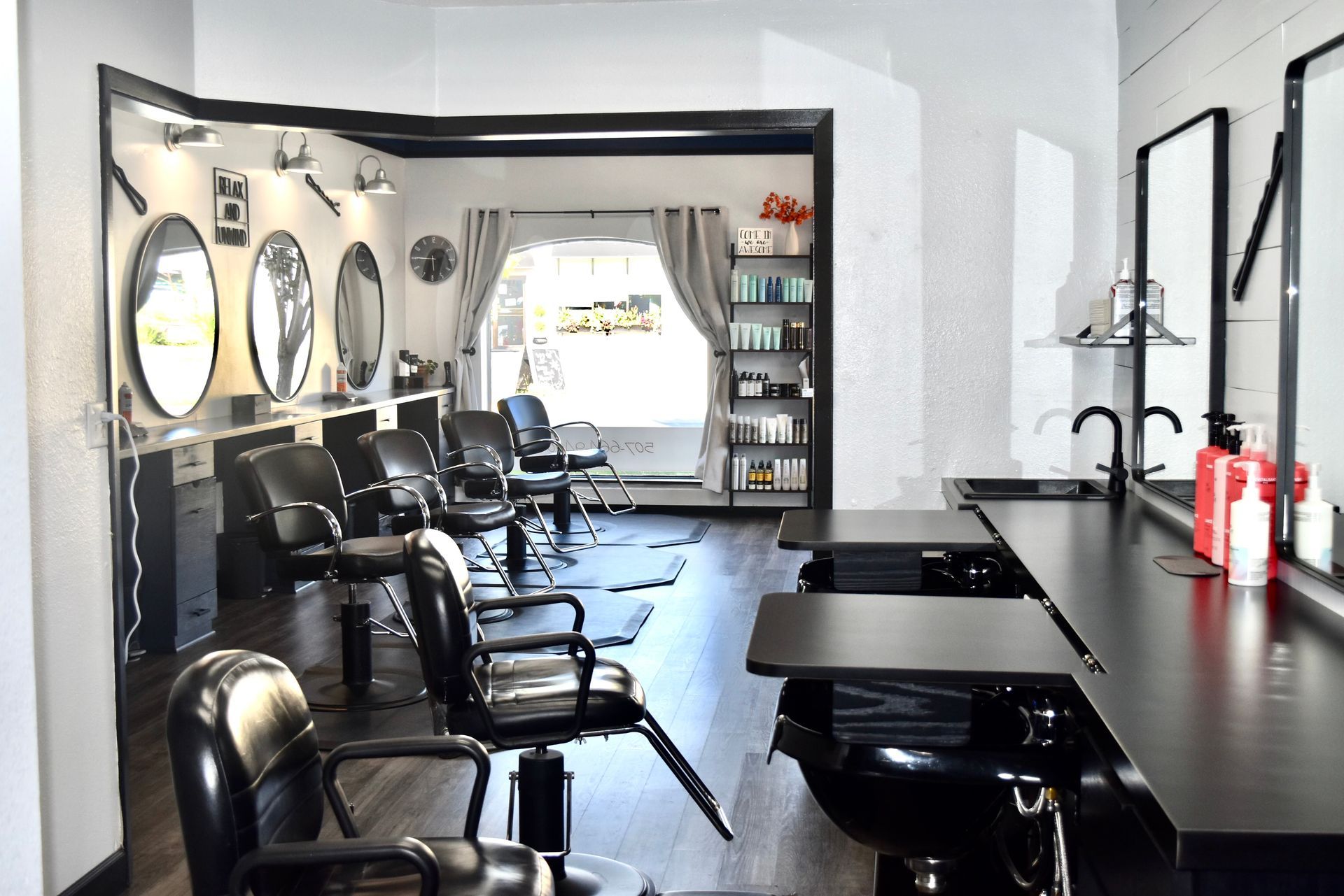 A hair salon with a lot of chairs and tables