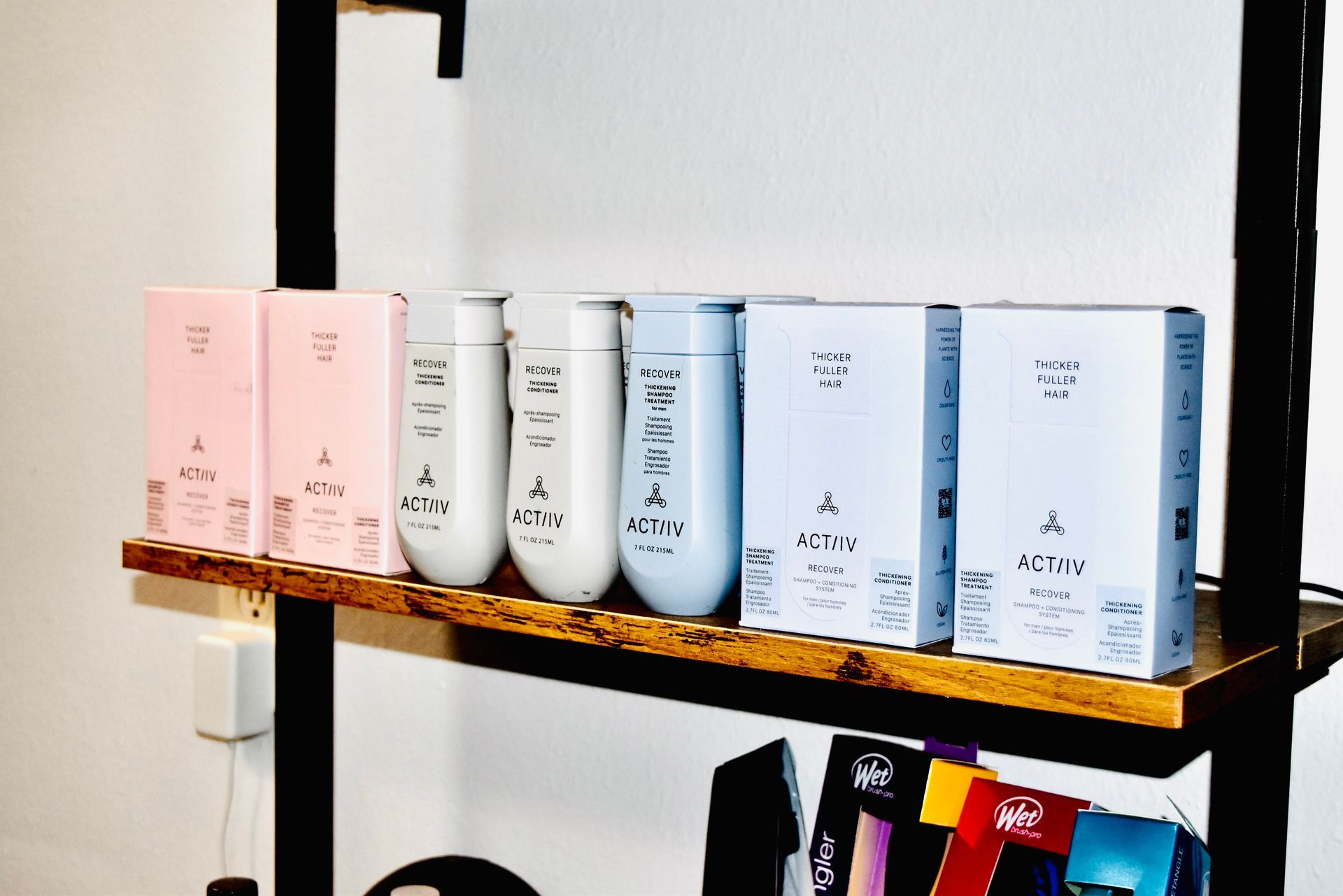 A shelf with a bunch of bottles and boxes on it