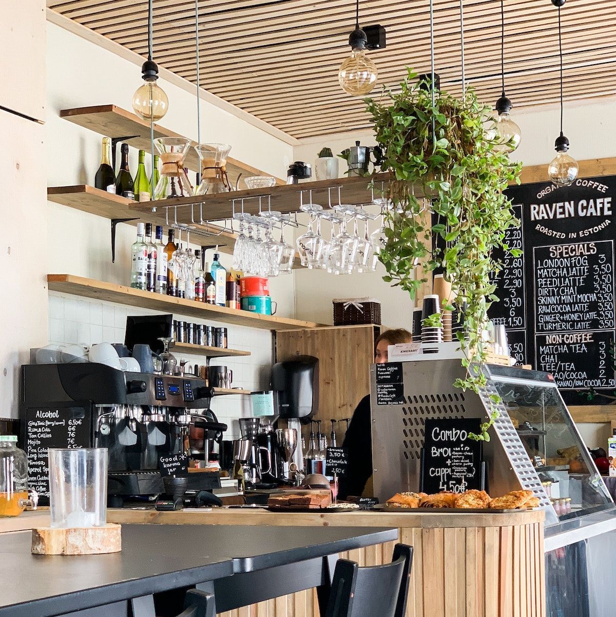A picture of a cafe with coffee machines and a display fridge requiring relocation.