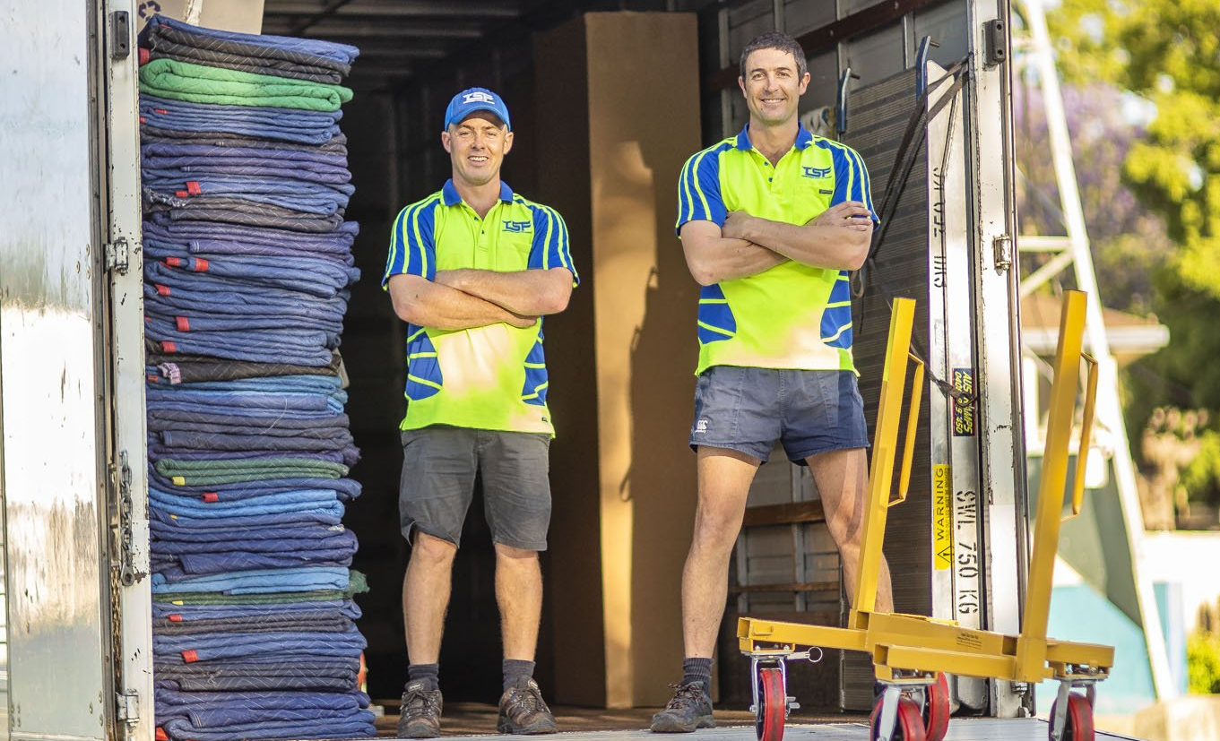 Lewis and Sam, the owners of Toowoomba Sensitive Freight, in the back of their truck.