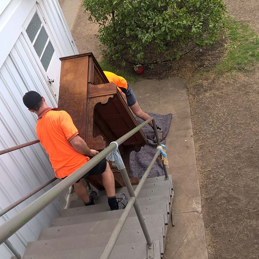 moving a piano down a staircase