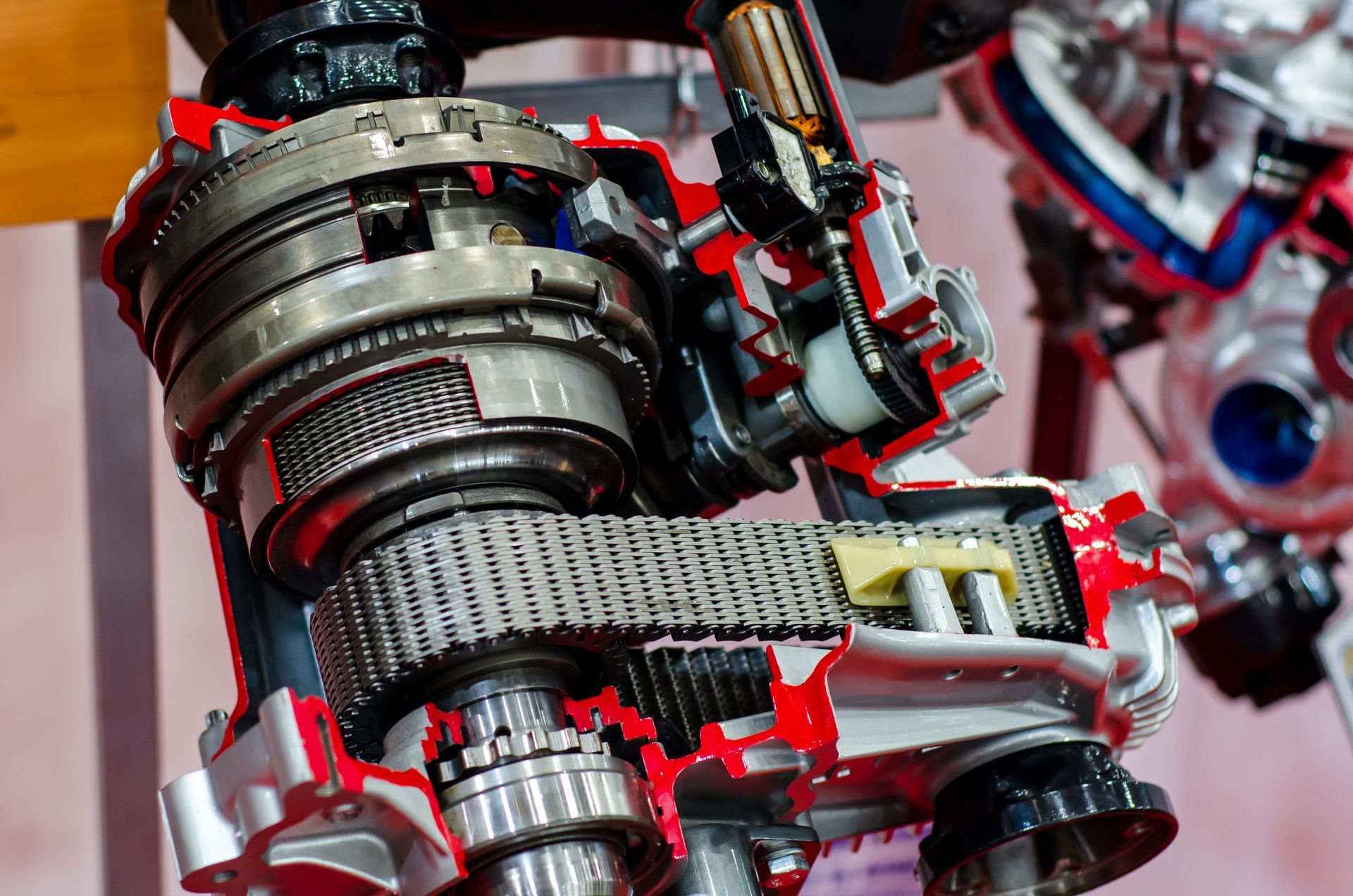 Close-up of a metallic robotic arm with red accents and cables in a futuristic setting