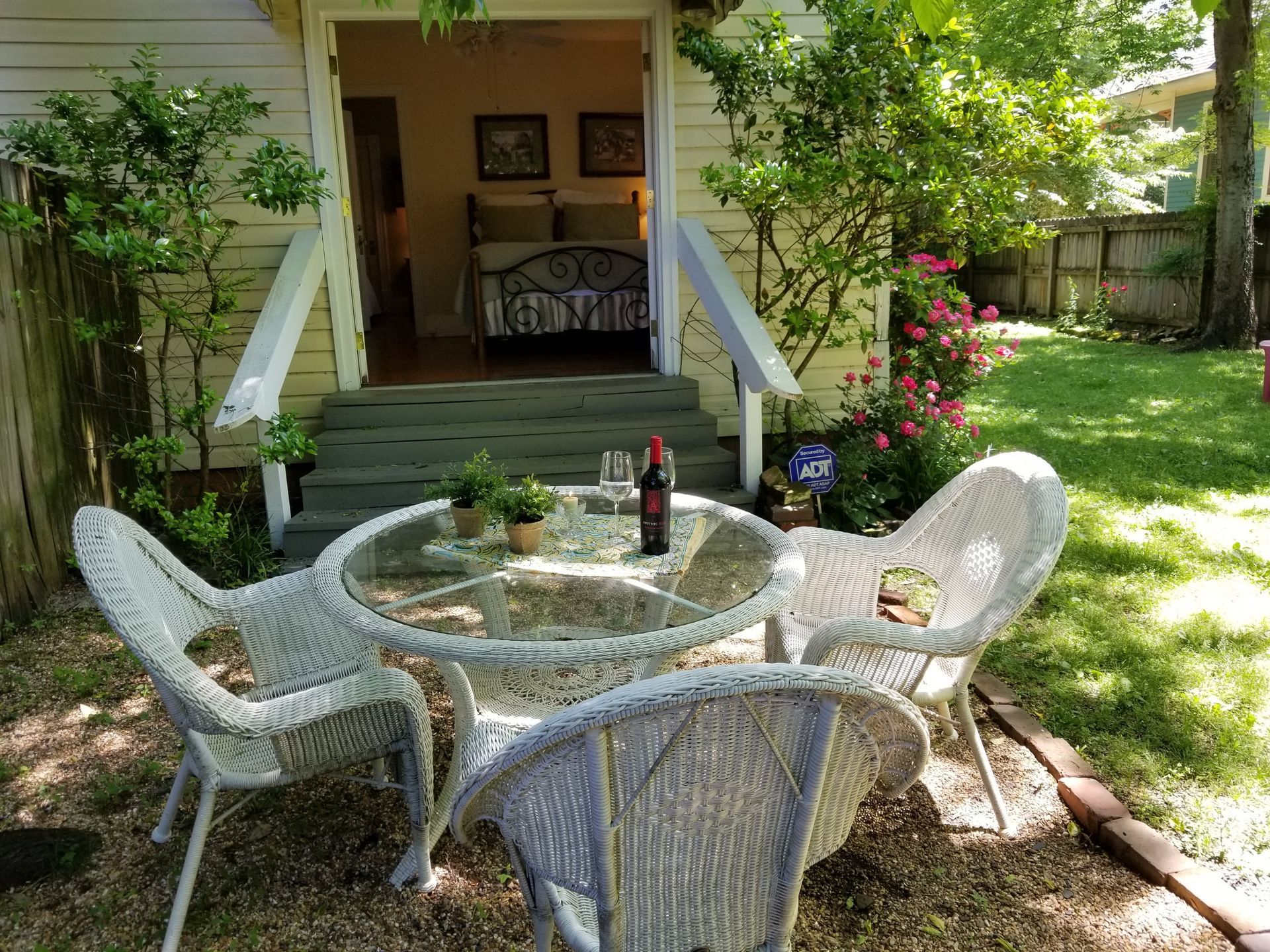 There is a table and chairs in front of a house.