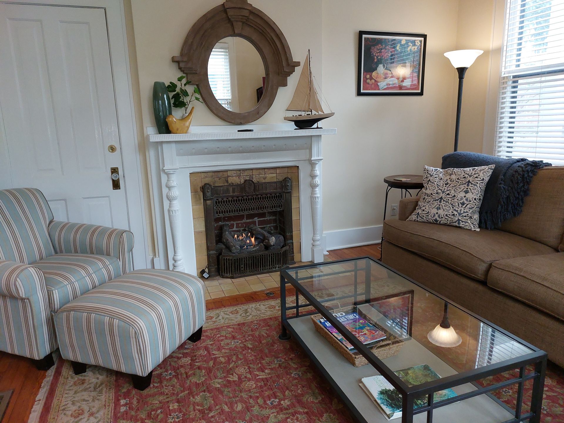 A living room with a couch a chair and a fireplace