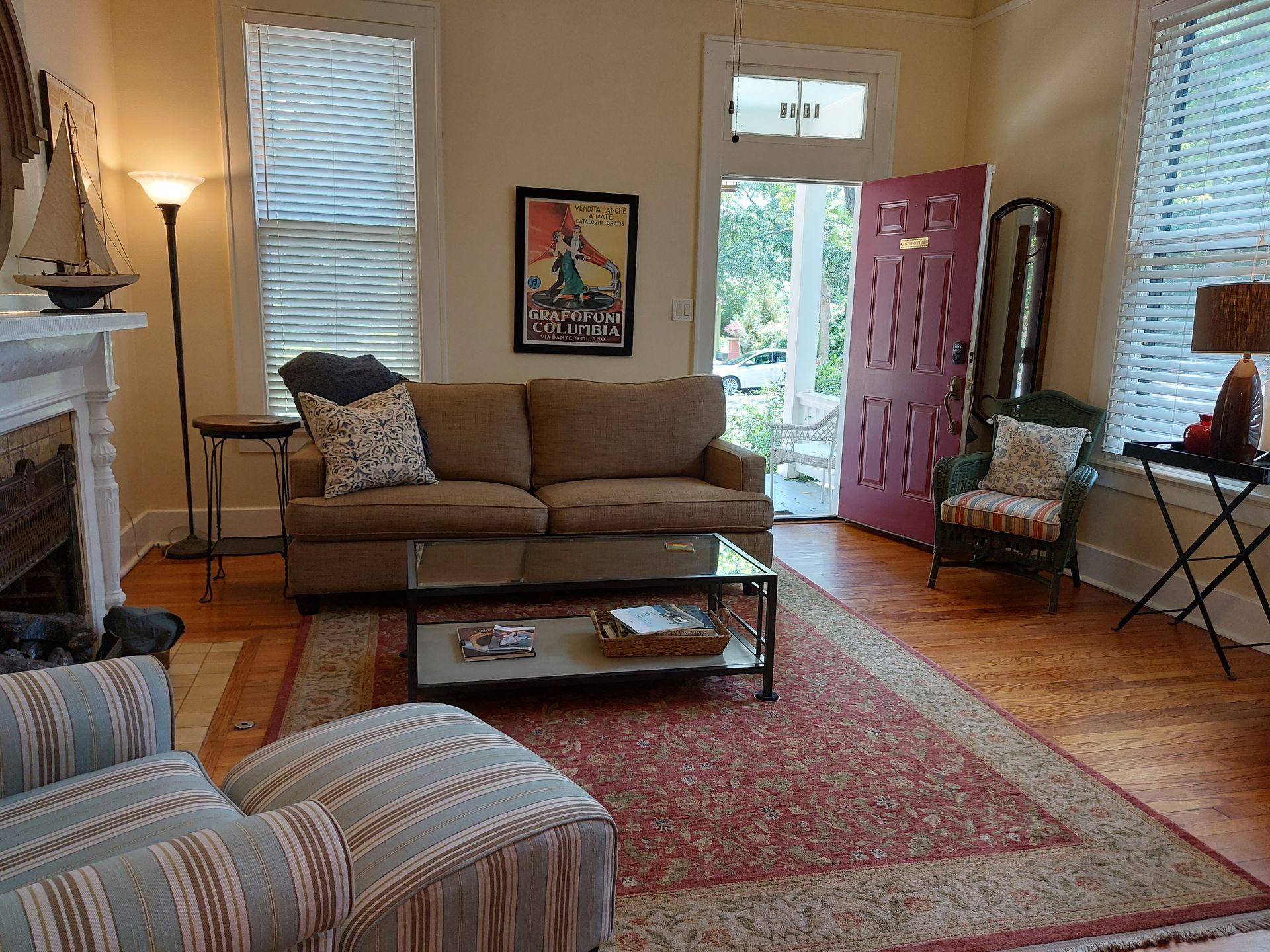 A living room with a brown couch and a red door
