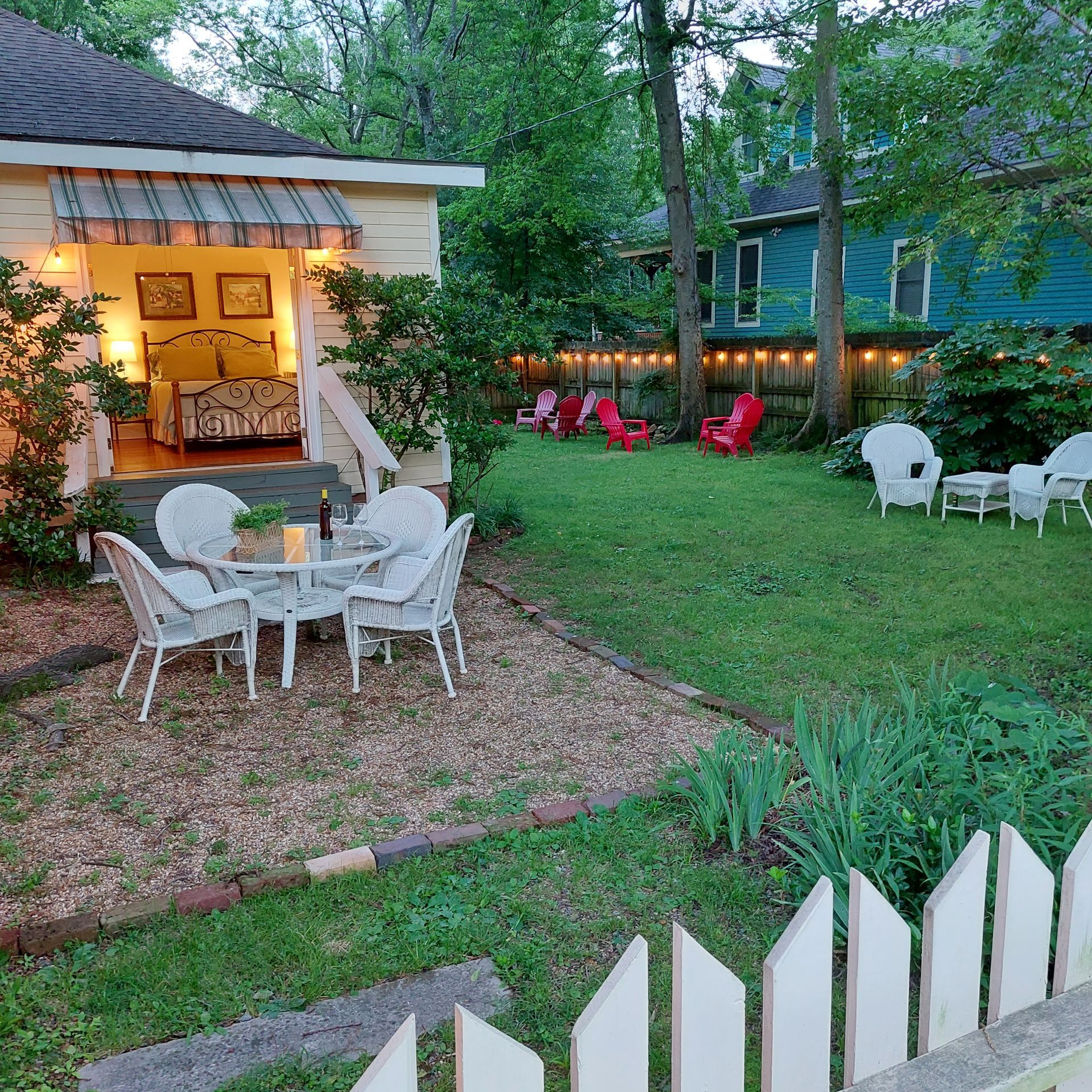 A house with a table and chairs in front of it