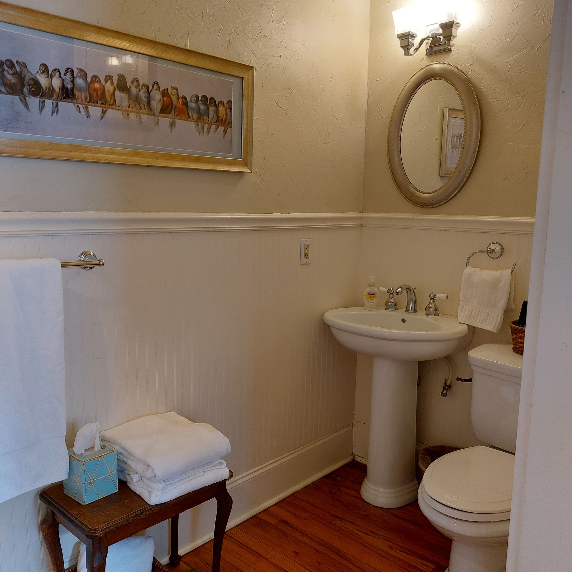 A bathroom with a sink a toilet and a mirror