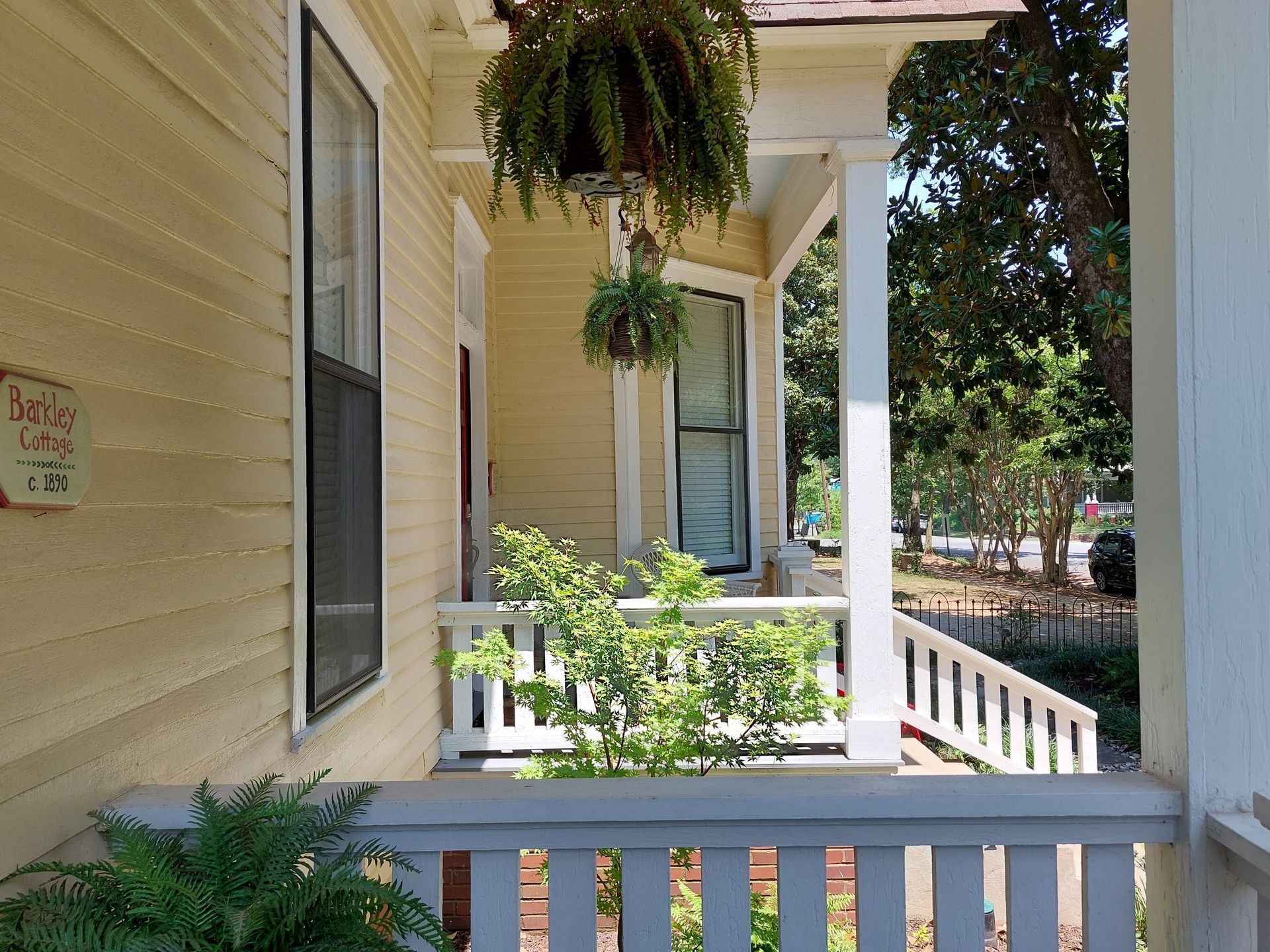 A porch of a house with a sign that says