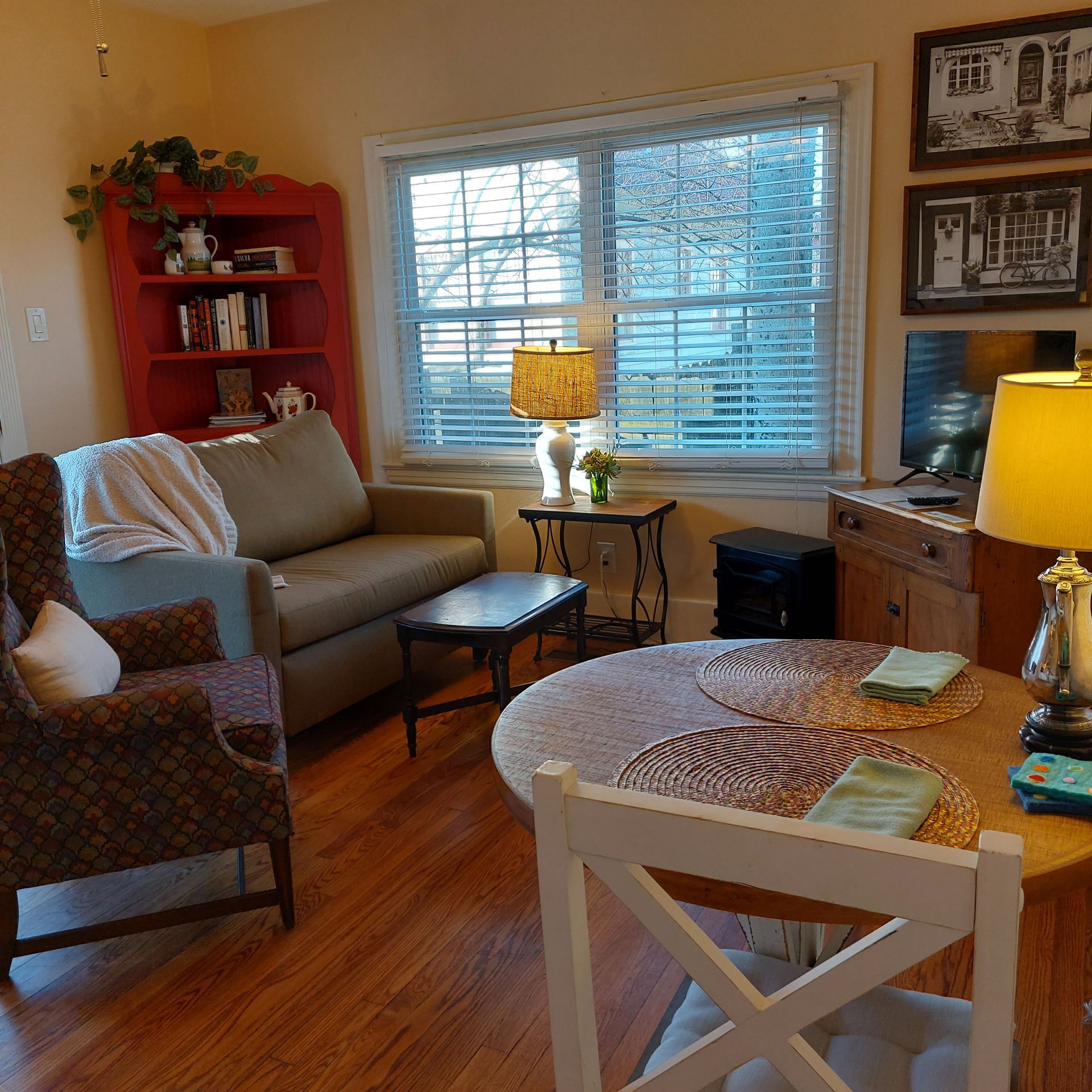 A living room with a couch a chair and a table