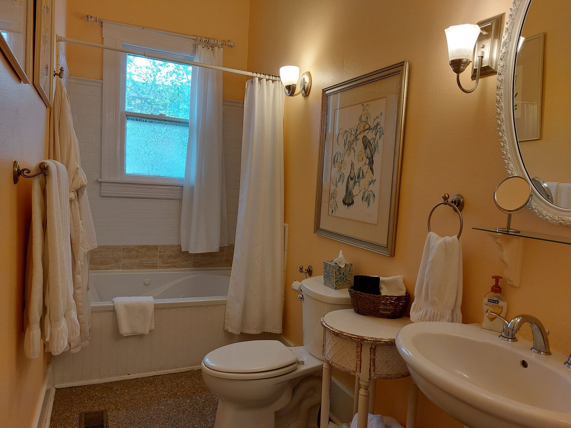 A bathroom with a toilet , sink , and bathtub.