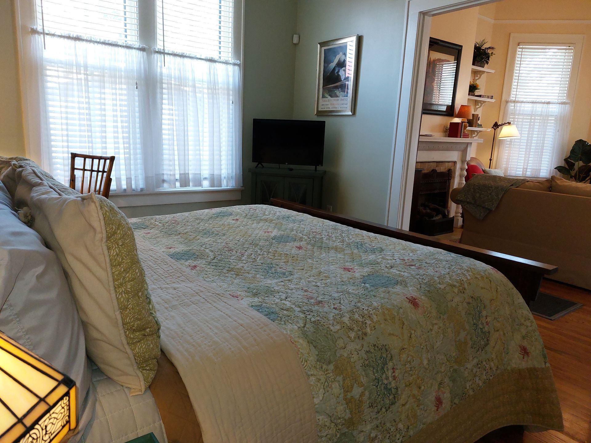 A bedroom with a large bed and a flat screen tv