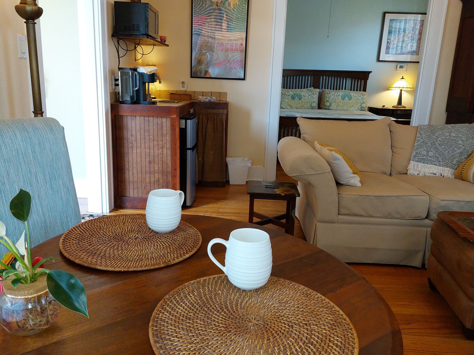 A living room with a couch and a table with two cups on it