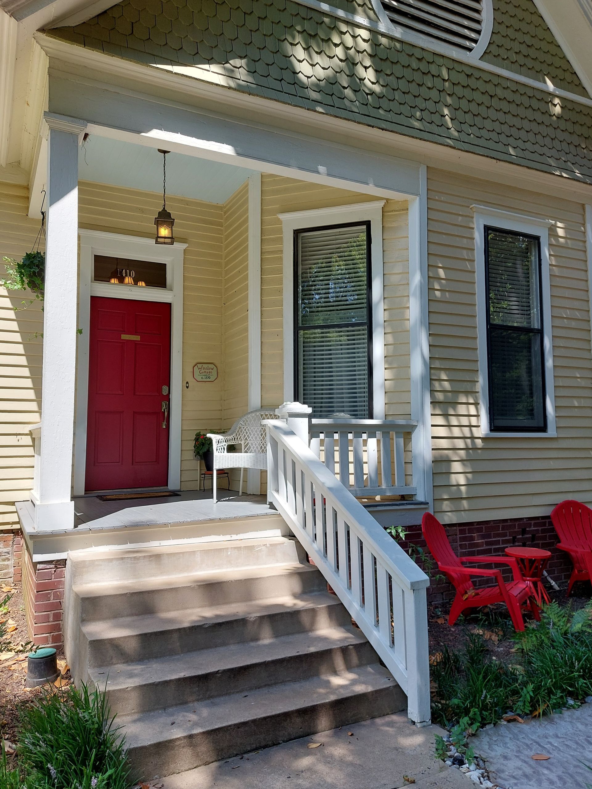 A house with a red door and stairs leading to it