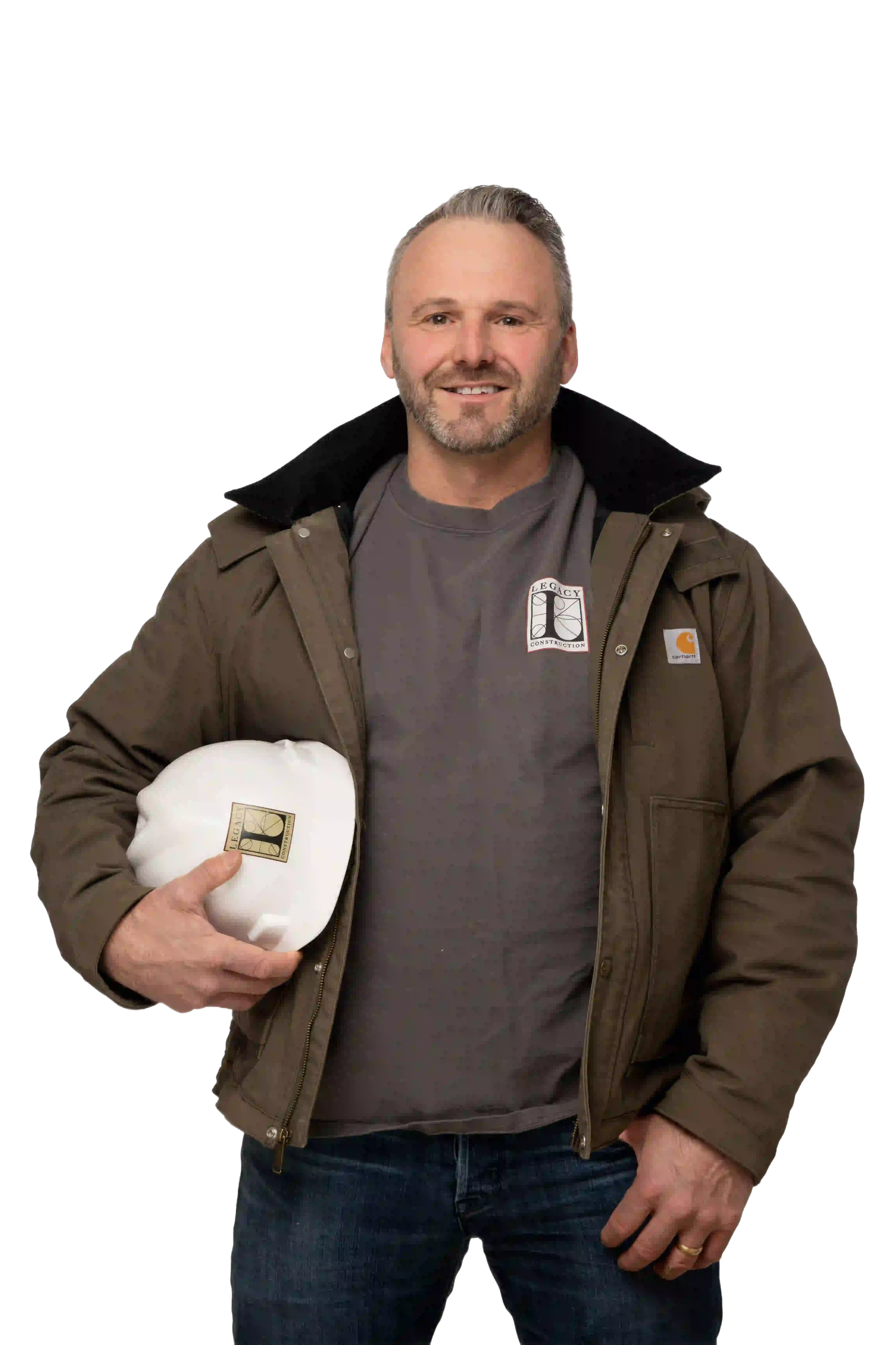 Construction worker in Carhartt jacket holding a hard hat, smiling.
