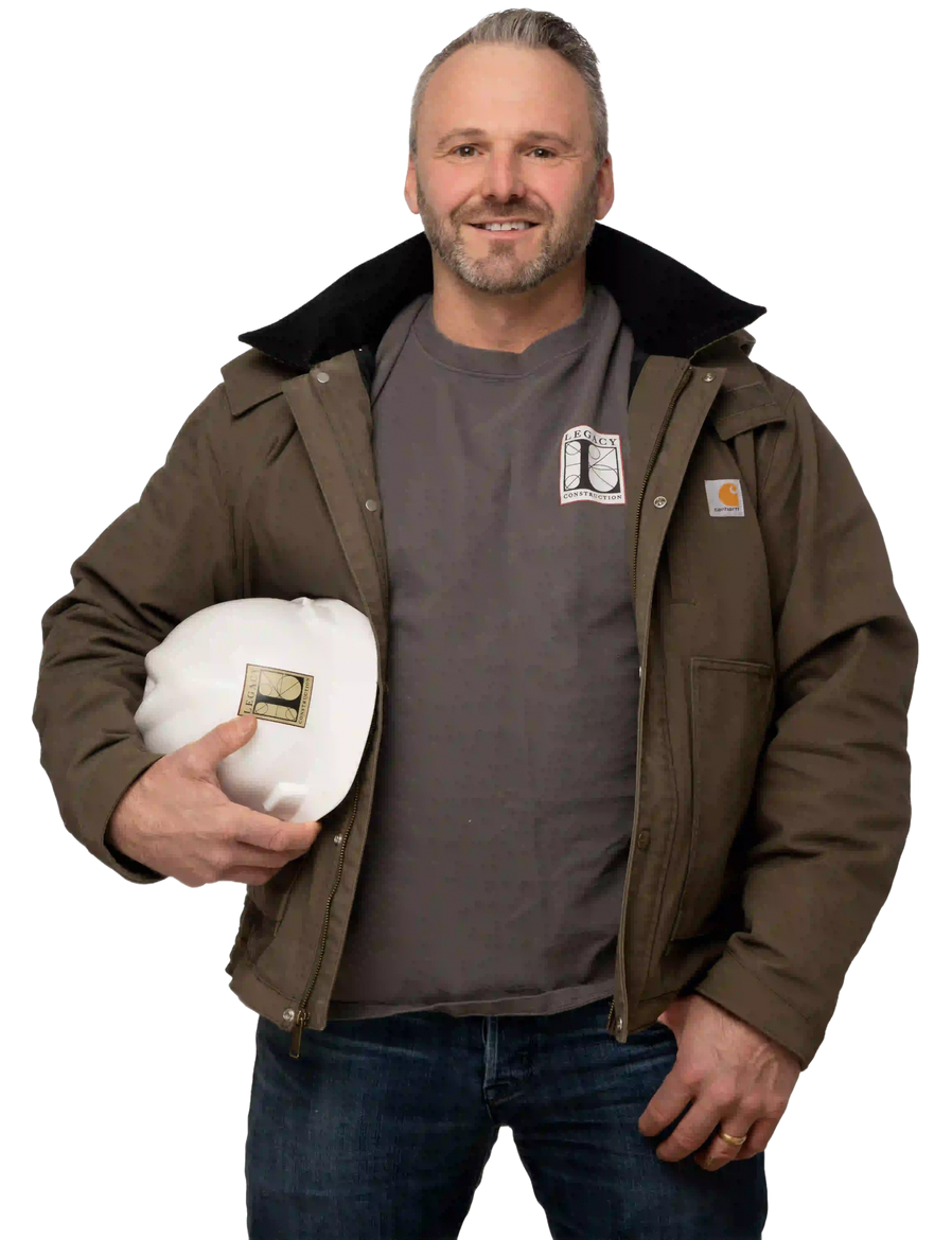 Man in a brown jacket holding a white hard hat against a plain white background