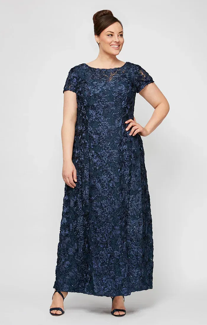 A woman is wearing a blue dress with a halter neckline and ruffles.