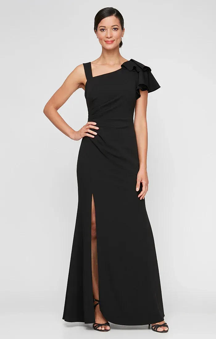 A woman is wearing a black one shoulder dress with ruffles.