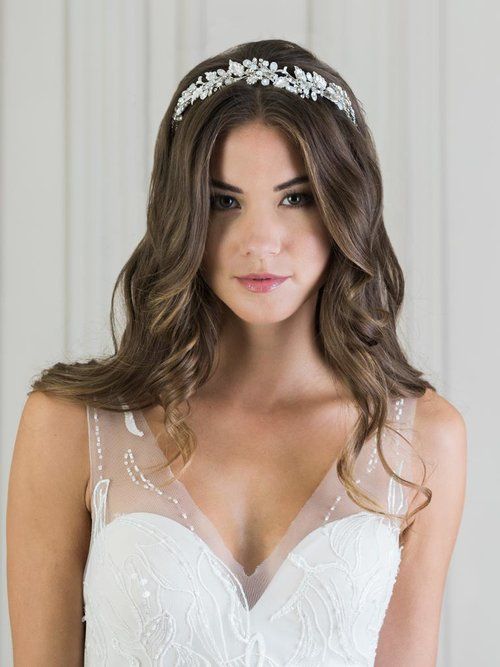 A woman in a wedding dress is wearing a headband.