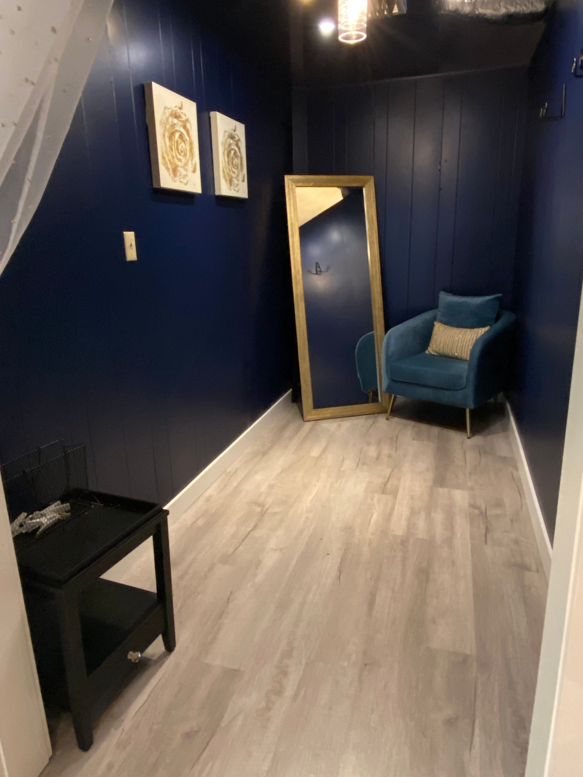 A room with a chair and a mirror in it