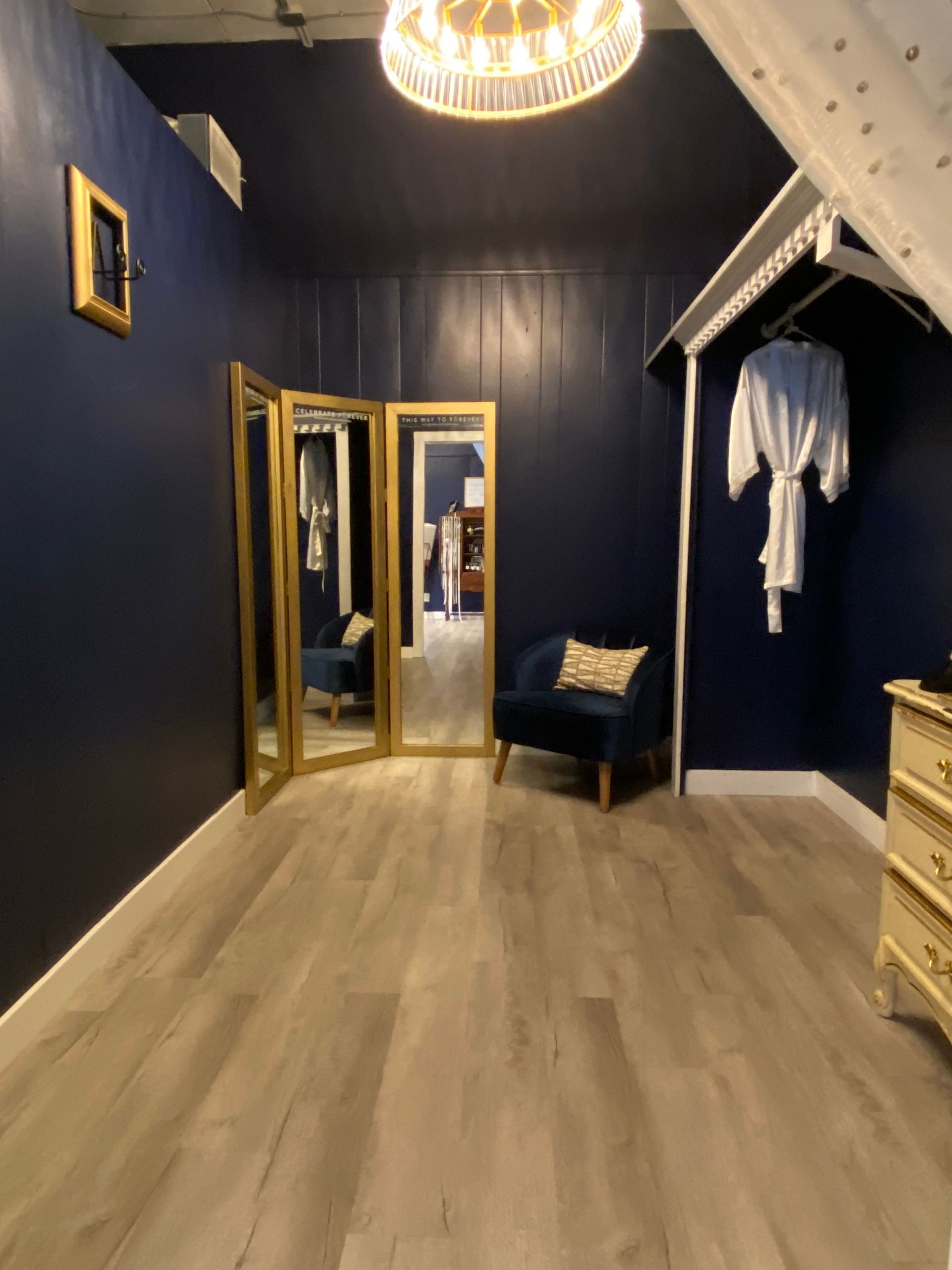 A room with blue walls and a large mirror