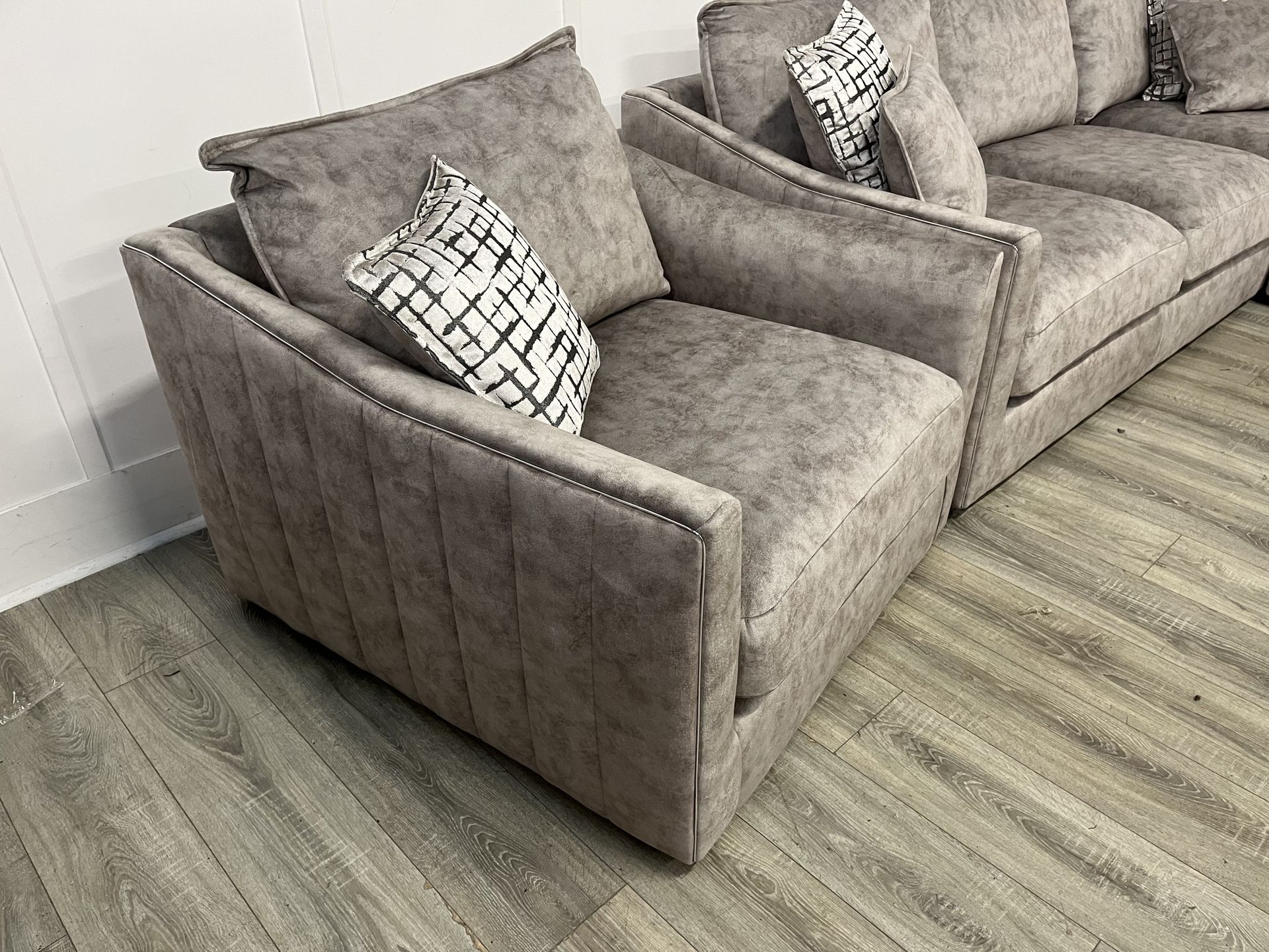 Two gray armchairs with patterned pillows on a light wood floor beside a gray sofa delivery in Rotherham