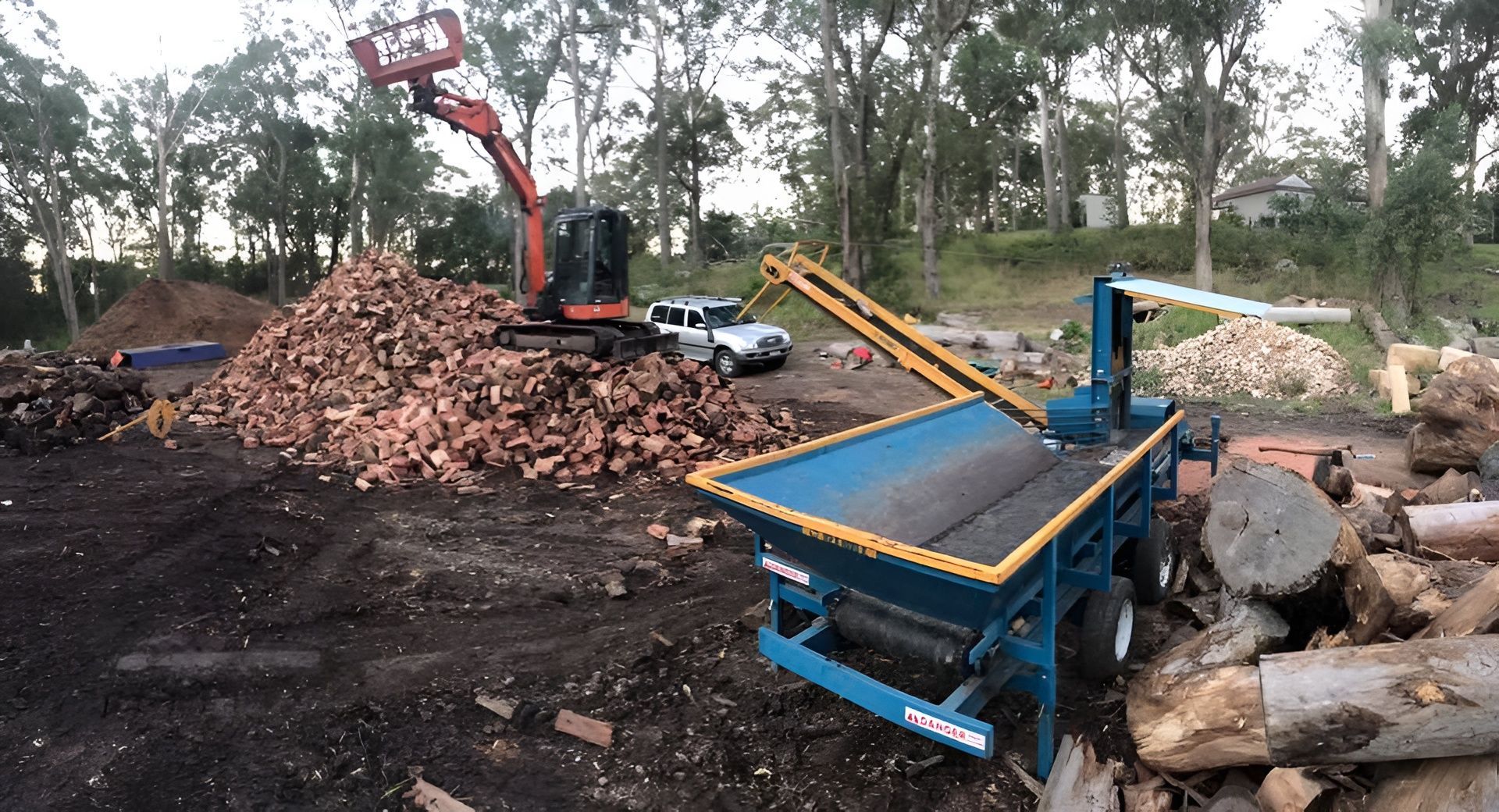 A Wood Processing Yard With an Excavator — All Tree Solutions in Kincumber, NSW
