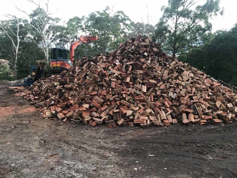 Large Pile of Reddish-brown Split Firewood — All Tree Solutions In Bateau Bay, NSW