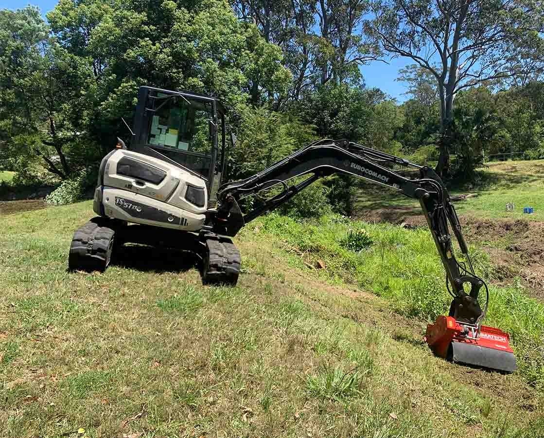 Small Excavator With Brush Cutter Attachment Clearing Vegetation — All Tree Solutions In Ourimbah, NSW