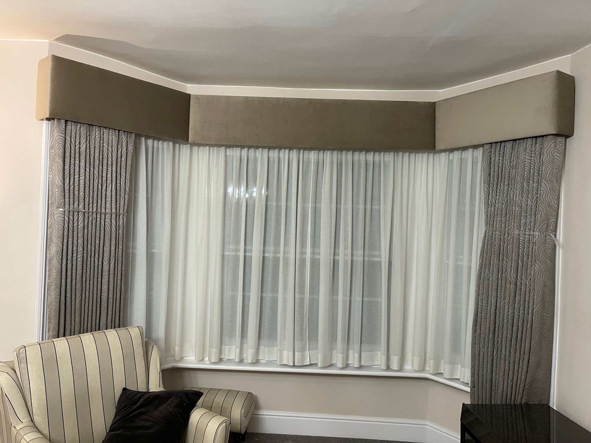 Bay window curtains with bespoke pelmet to hide the curtain track