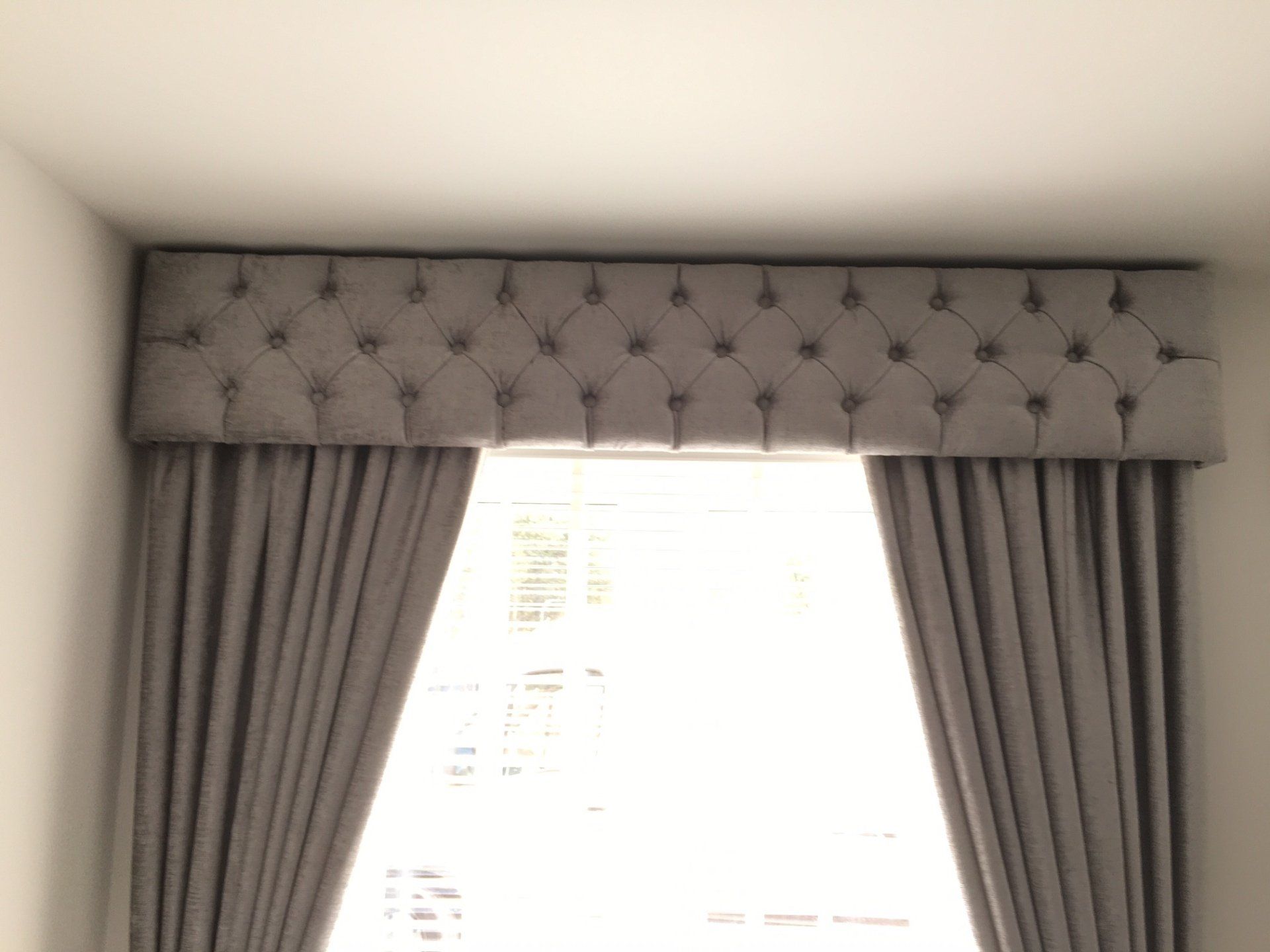 Custom made deep buttoned pelmet with matching fabric curtains