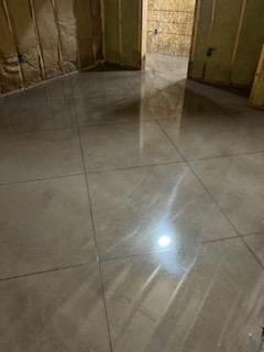 A room with a tiled floor and a door.