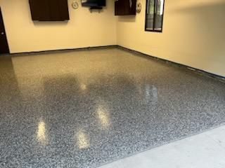 A garage with a gray floor and white walls.