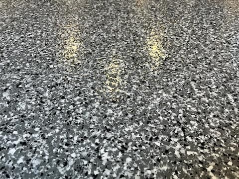 A close up of a gray and white marble floor.