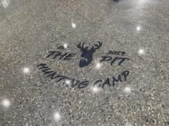 The logo for the pit hunting camp is on the floor.