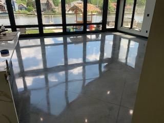 A room with a lot of windows and a shiny floor.