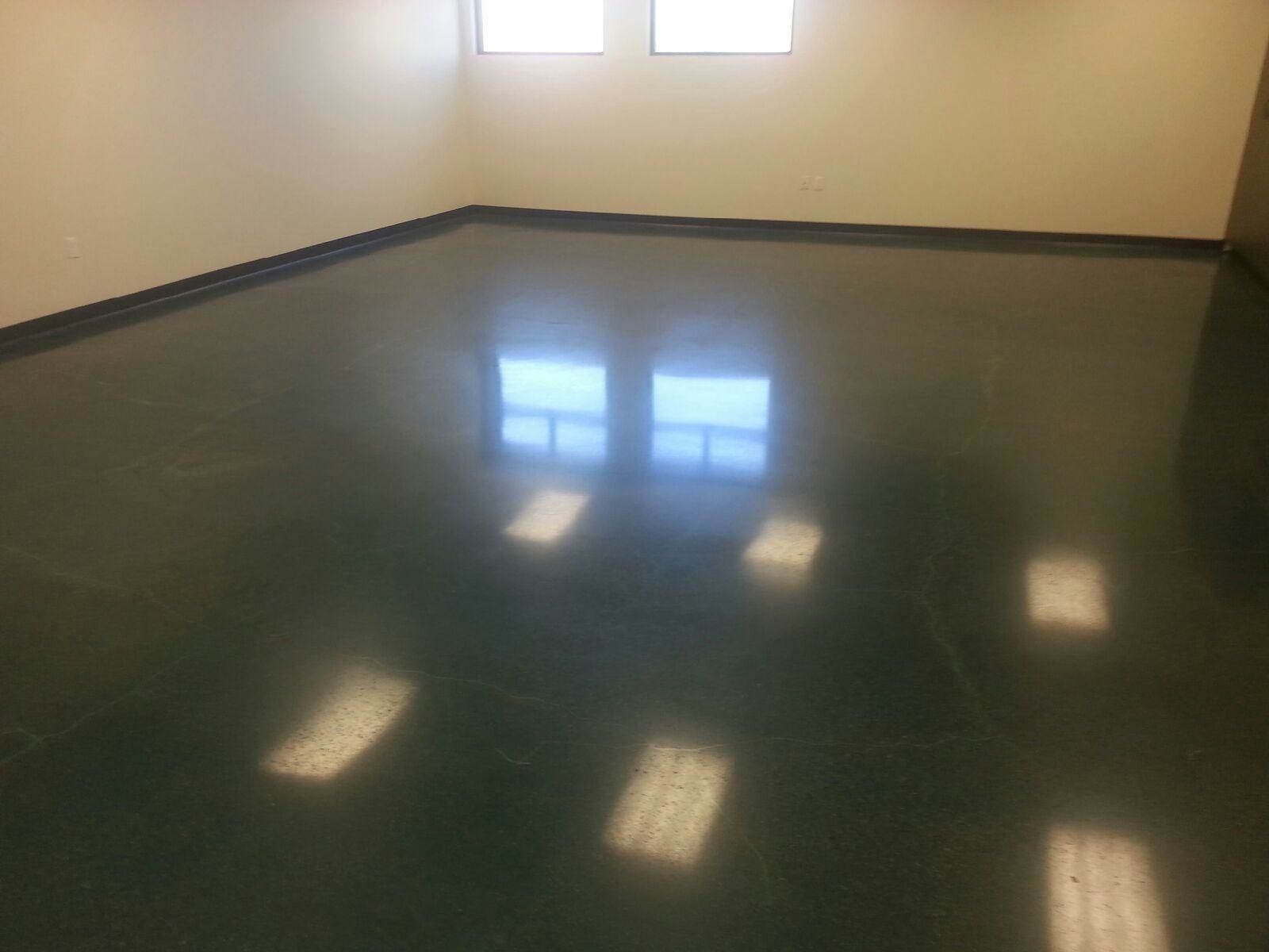 A room with a green floor and white walls.