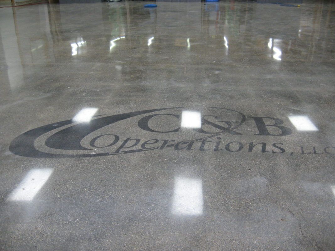 A shiny concrete floor with a logo on it.