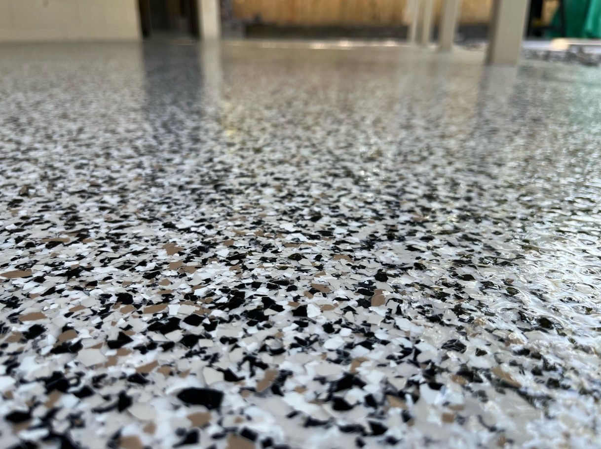 A close up of a black and white epoxy floor.