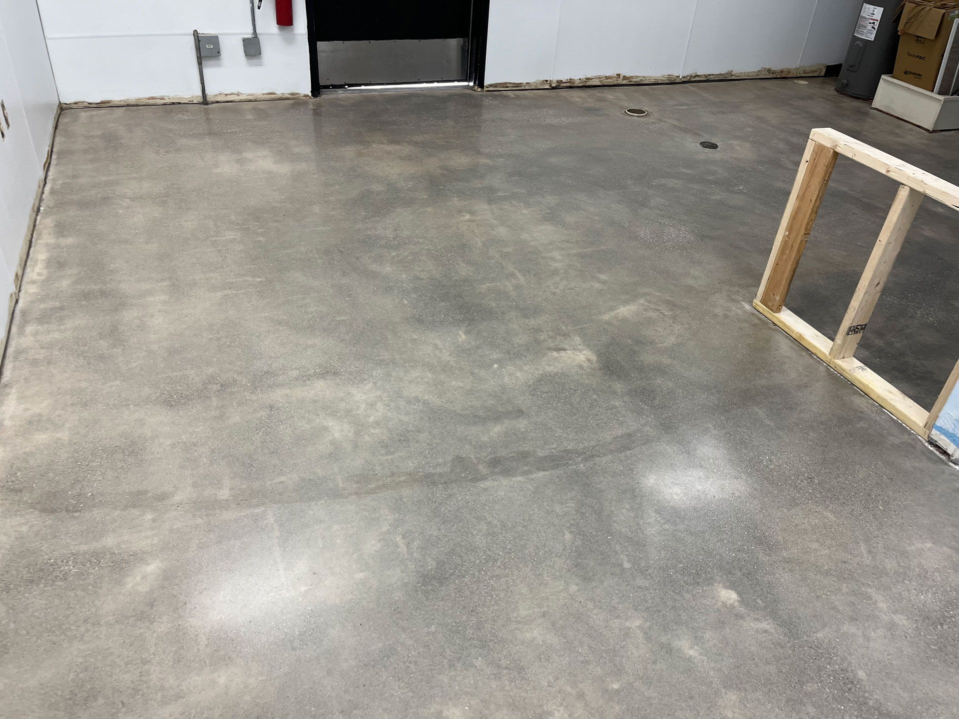 A concrete floor with a wooden frame on it in a room.