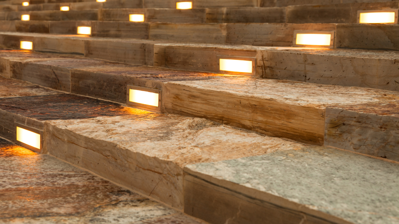 A row of stone stairs with lights on them.