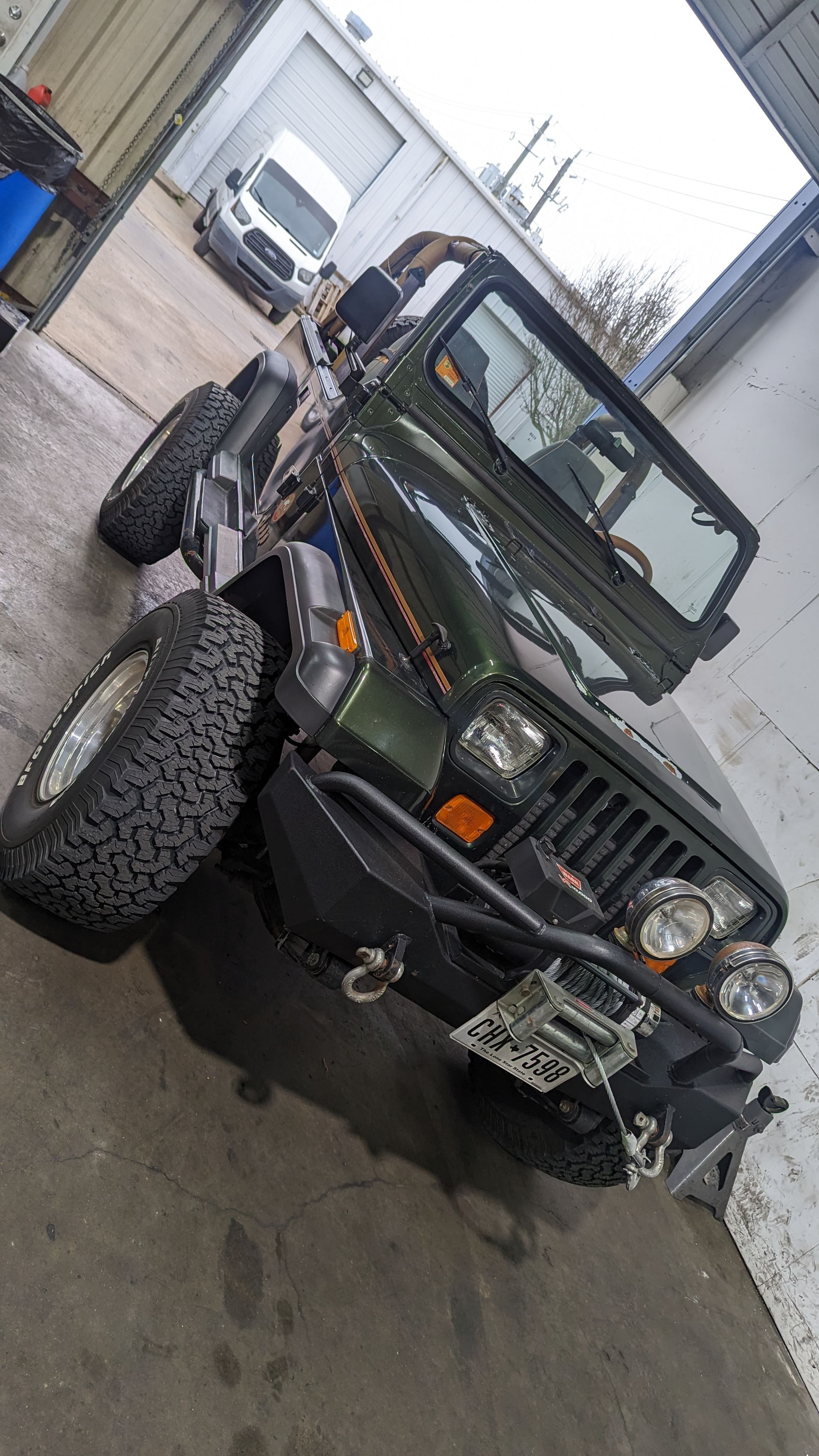 Black Jeep With Off-Road Modifications In Shop | Full-Service Auto Repair