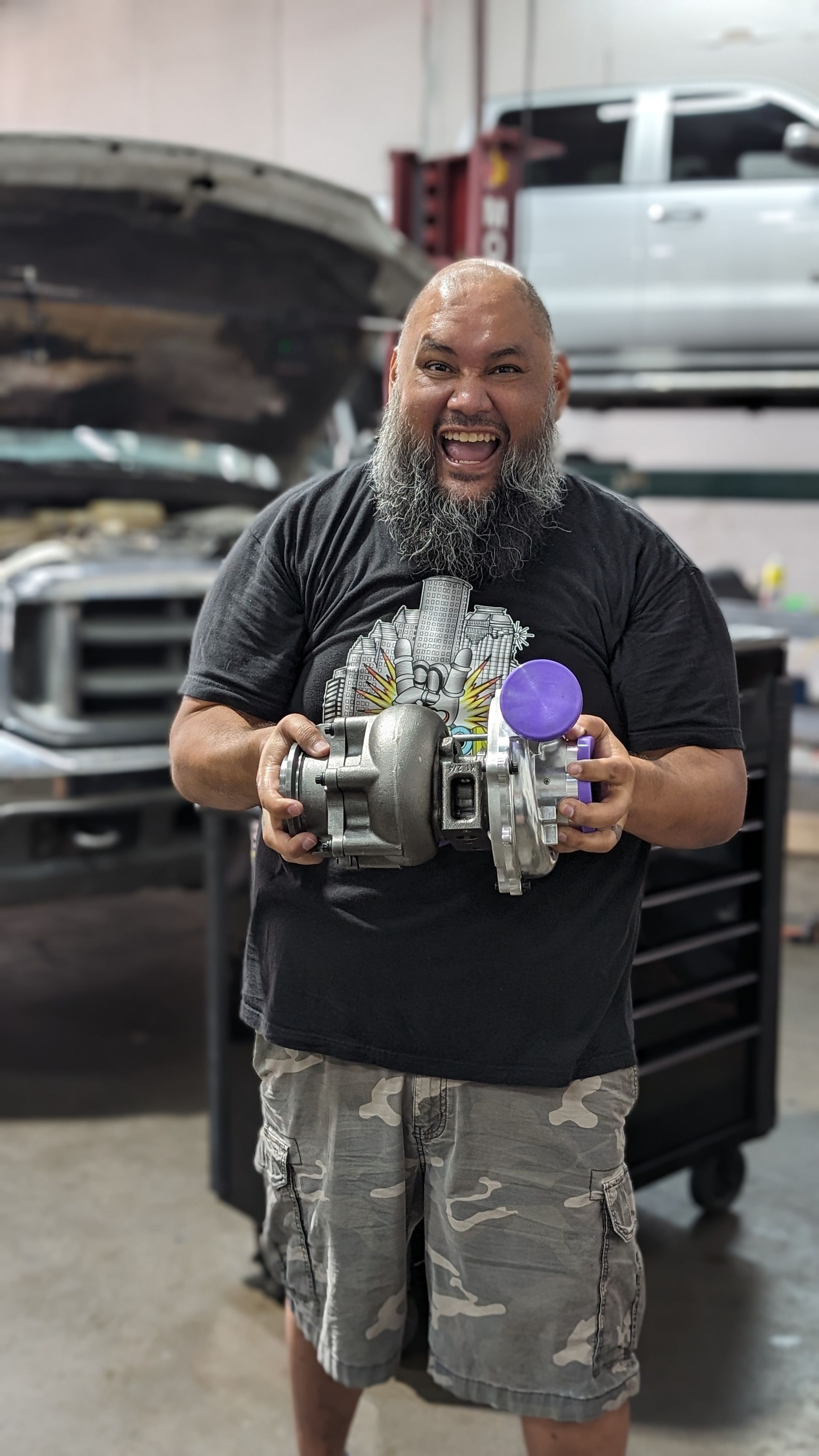Technician Holding Auto Parts With A Smile | Full-Service Auto Repair
