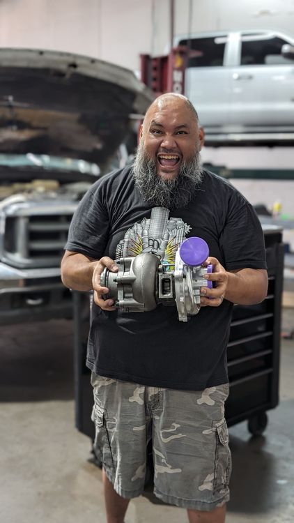 Technician Holding Auto Parts With A Smile | Full-Service Auto Repair
