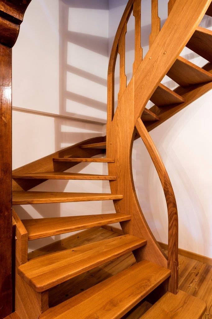 Una scala a chiocciola in legno in una stanza